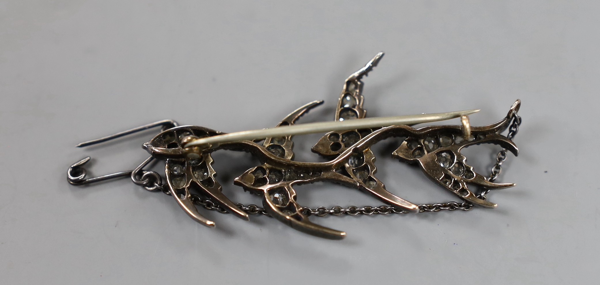 A Victorian yellow and white metal, cabochon ruby and old and rose cut diamond cluster set quadruple swallow brooch, with replaced pin, but original pin present, 47mm, gross weight 6 grams.
